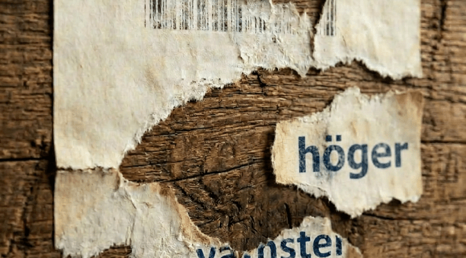Torn shipping label on rough wooden crate with partial text 'LOT 42 FRAGILE SHIP T'